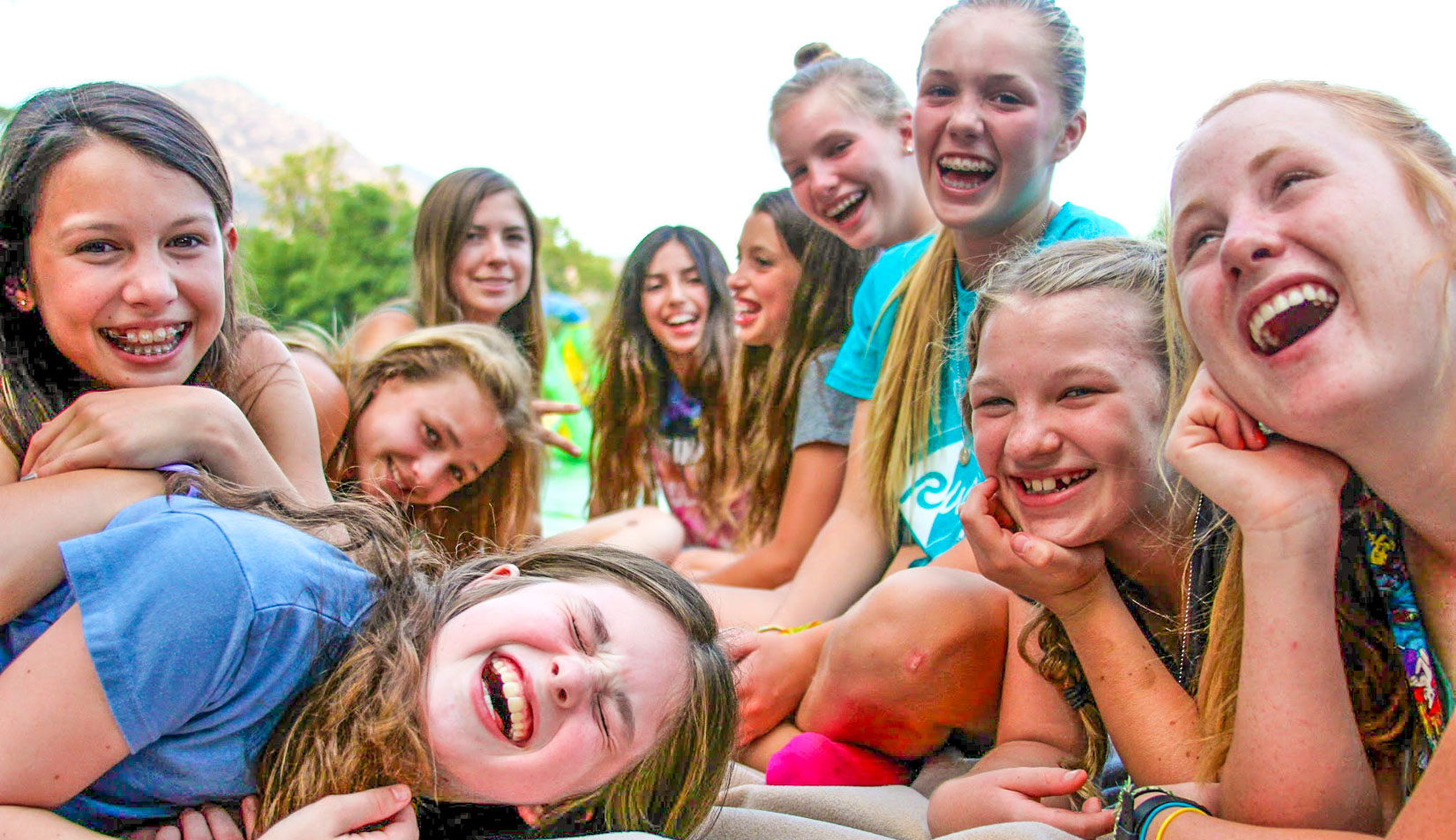A group of campers laughing and smiling.