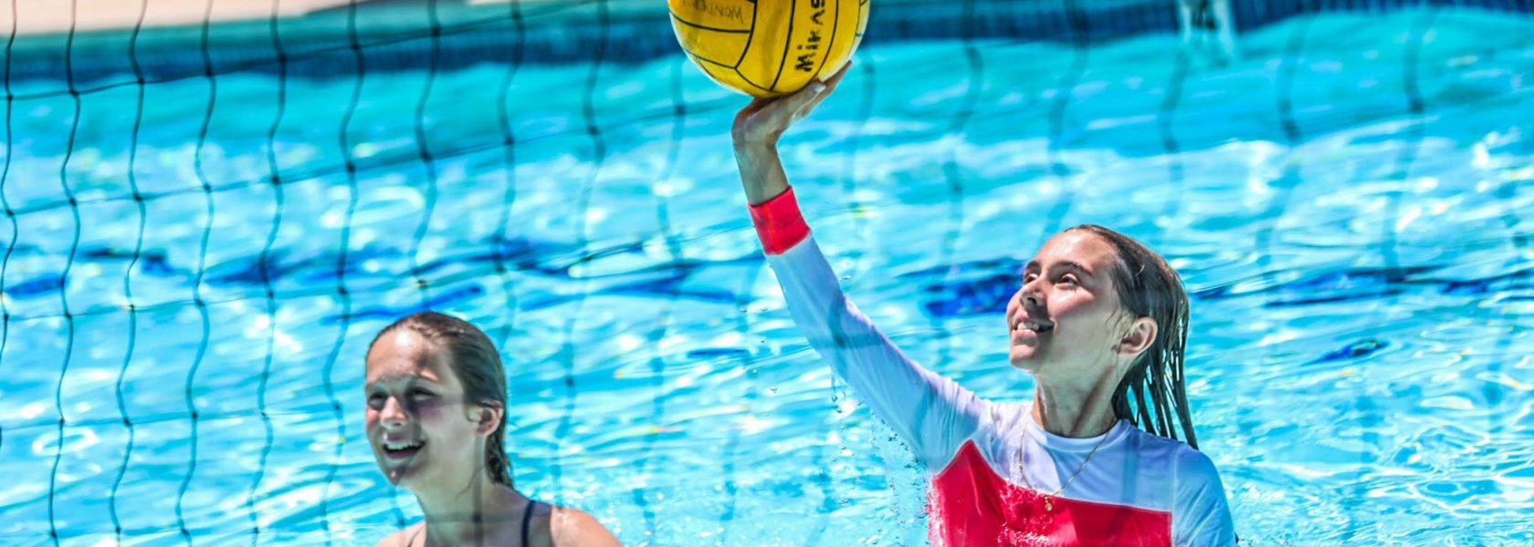 A camper playing water volleyball